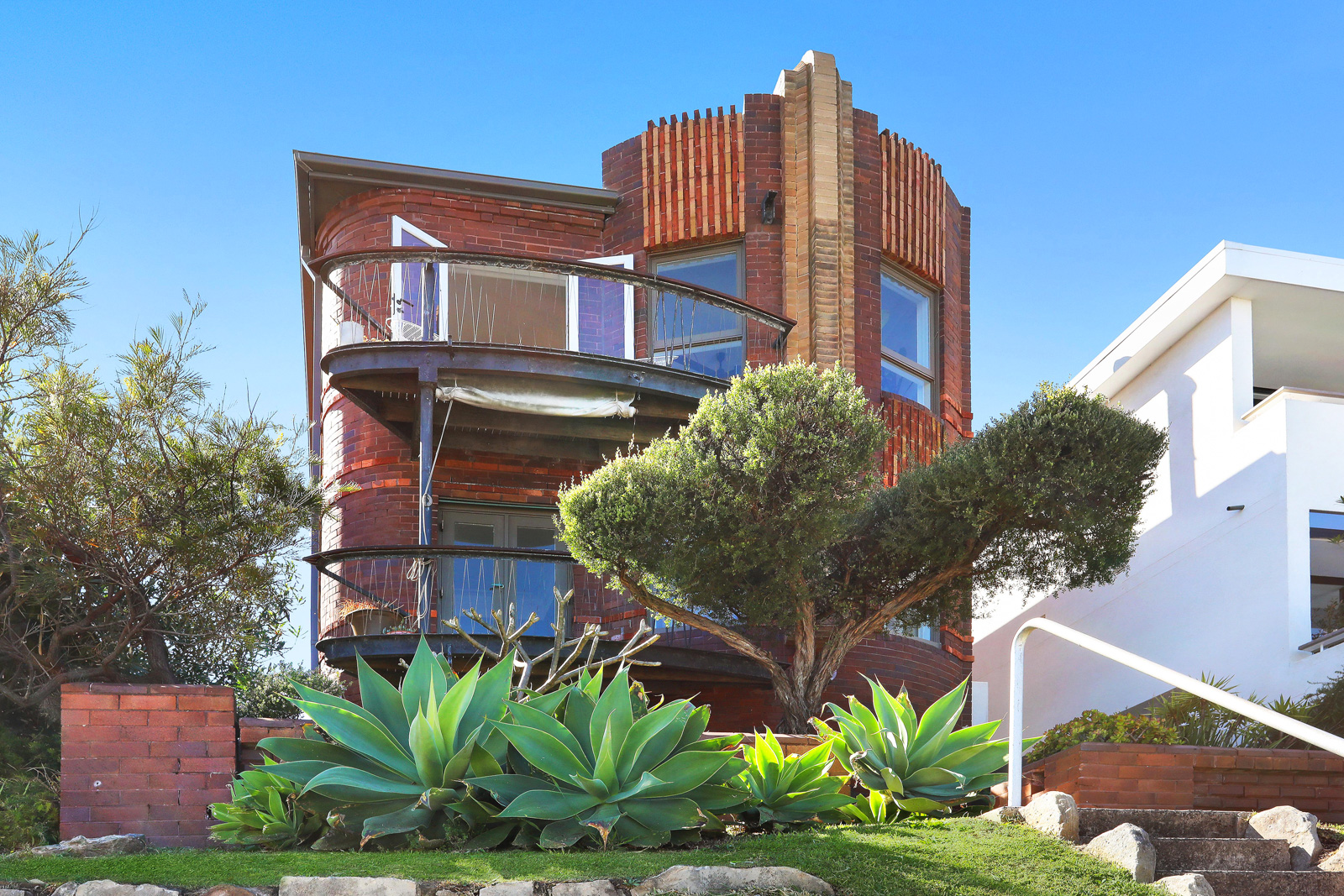 A red brick art deco building on Ben Buckler Point North Bondi 3 apartments over two floors
